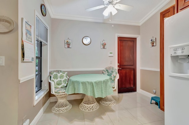 tiled dining area with crown molding and ceiling fan