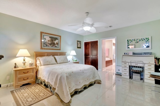 bedroom with ceiling fan, ensuite bath, and light tile patterned floors