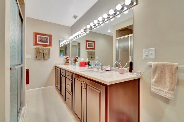 bathroom featuring vanity and a shower with door