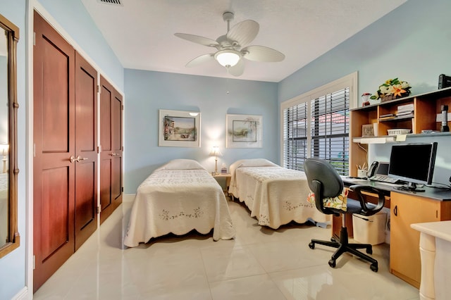 bedroom featuring a closet, light tile patterned flooring, and ceiling fan