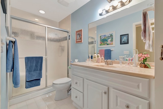 bathroom featuring tile patterned flooring, a shower with door, vanity, and toilet