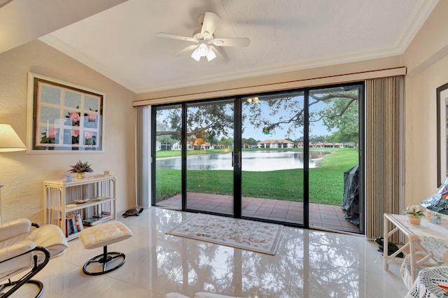 living room featuring ceiling fan, lofted ceiling, light tile patterned floors, ornamental molding, and a water view