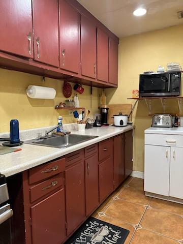 kitchen featuring light tile patterned flooring and sink