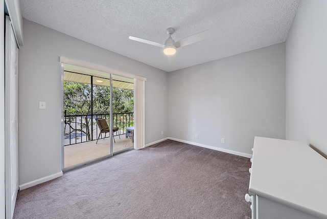 carpeted empty room featuring a textured ceiling and ceiling fan