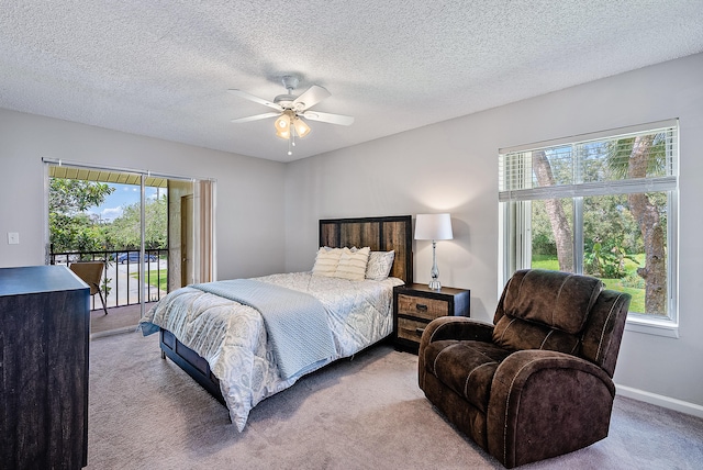 carpeted bedroom featuring a textured ceiling, ceiling fan, and access to outside