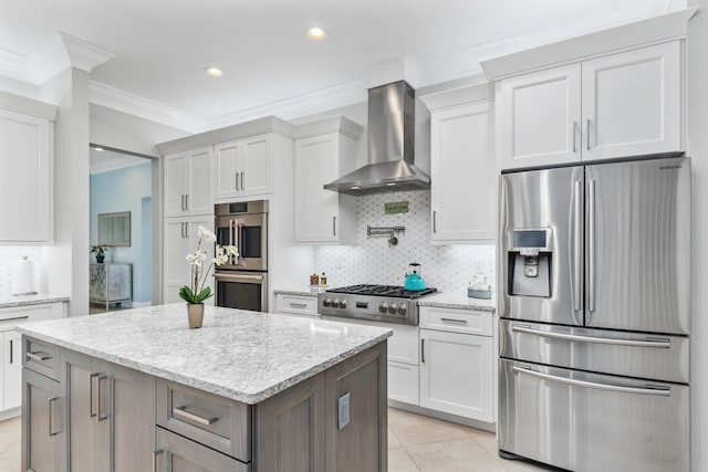 kitchen featuring light tile patterned floors, wall chimney exhaust hood, white cabinetry, appliances with stainless steel finishes, and light stone countertops