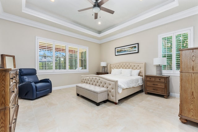 bedroom featuring ceiling fan, a tray ceiling, and ornamental molding