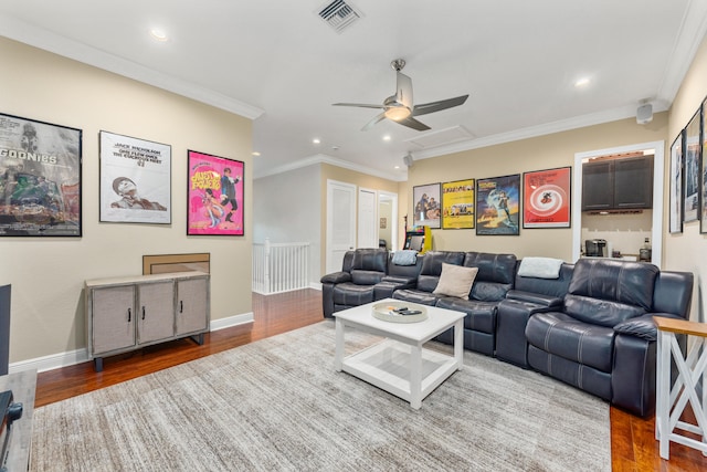 living room with wood-type flooring, crown molding, and ceiling fan