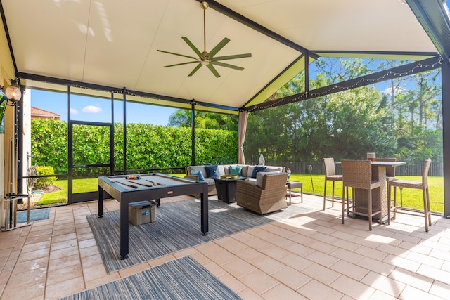 exterior space featuring ceiling fan and an outdoor living space with a fire pit