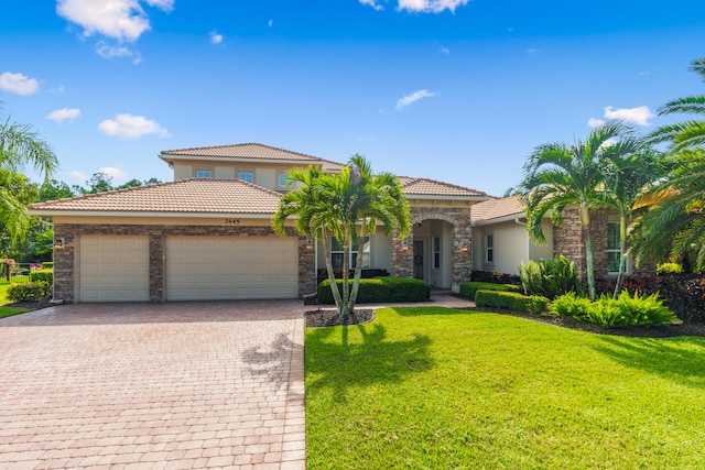 mediterranean / spanish home with a front yard and a garage