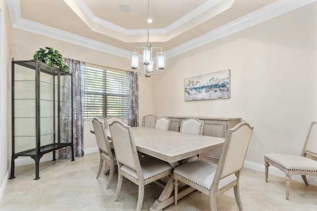 dining room with crown molding, a chandelier, and a tray ceiling