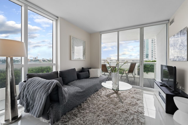 living room with expansive windows, tile patterned flooring, and a wealth of natural light