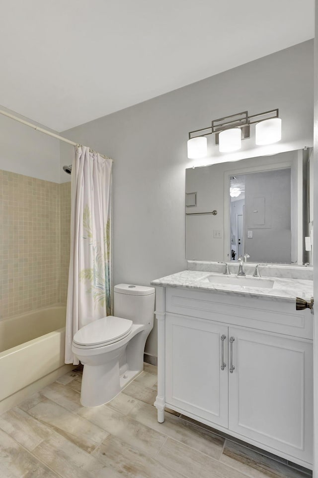 full bathroom featuring vanity, shower / tub combo, and toilet