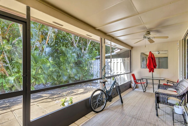 unfurnished sunroom with ceiling fan