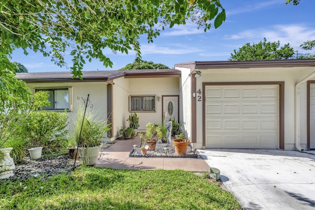 ranch-style home with an attached garage and driveway