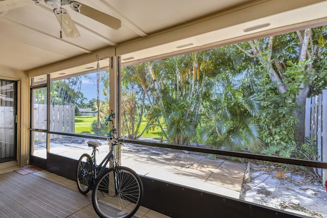 unfurnished sunroom with ceiling fan