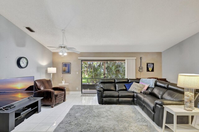 living area featuring visible vents, a textured ceiling, light tile patterned floors, lofted ceiling, and ceiling fan