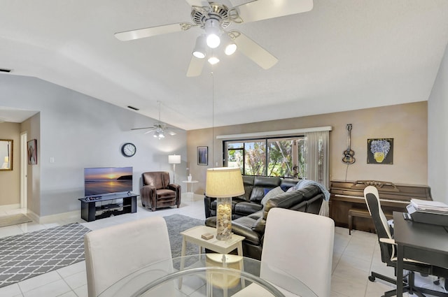 living area featuring ceiling fan, visible vents, light tile patterned flooring, and vaulted ceiling