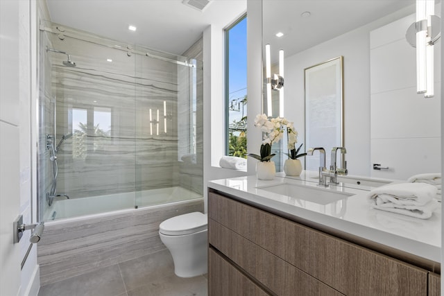 full bathroom with vanity, toilet, and enclosed tub / shower combo