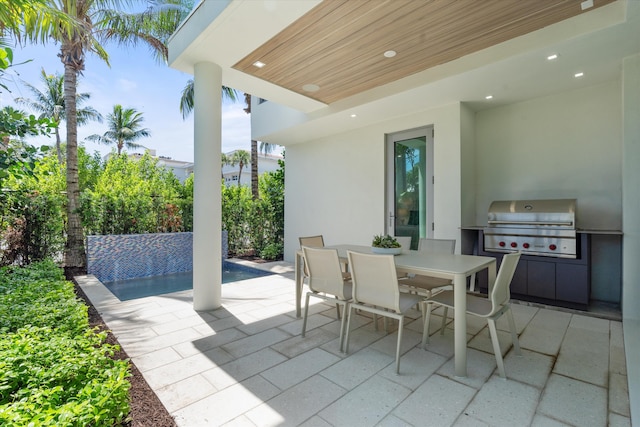 view of patio with an outdoor kitchen and area for grilling