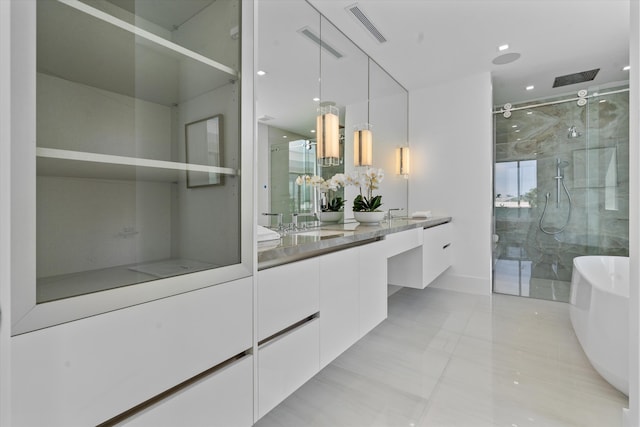 bathroom featuring tile patterned floors, vanity, and independent shower and bath