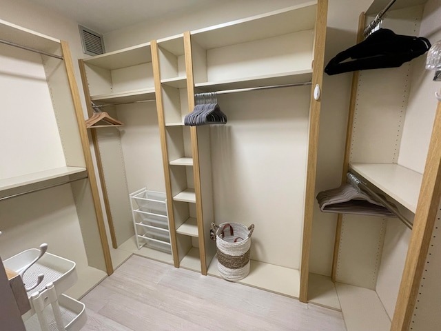 spacious closet featuring light hardwood / wood-style floors