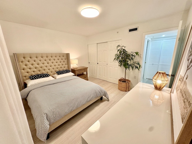 bedroom featuring light hardwood / wood-style floors and a closet