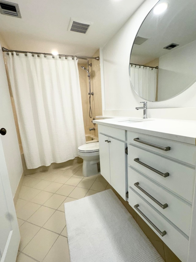 full bathroom featuring vanity, toilet, shower / bath combo with shower curtain, and tile patterned flooring