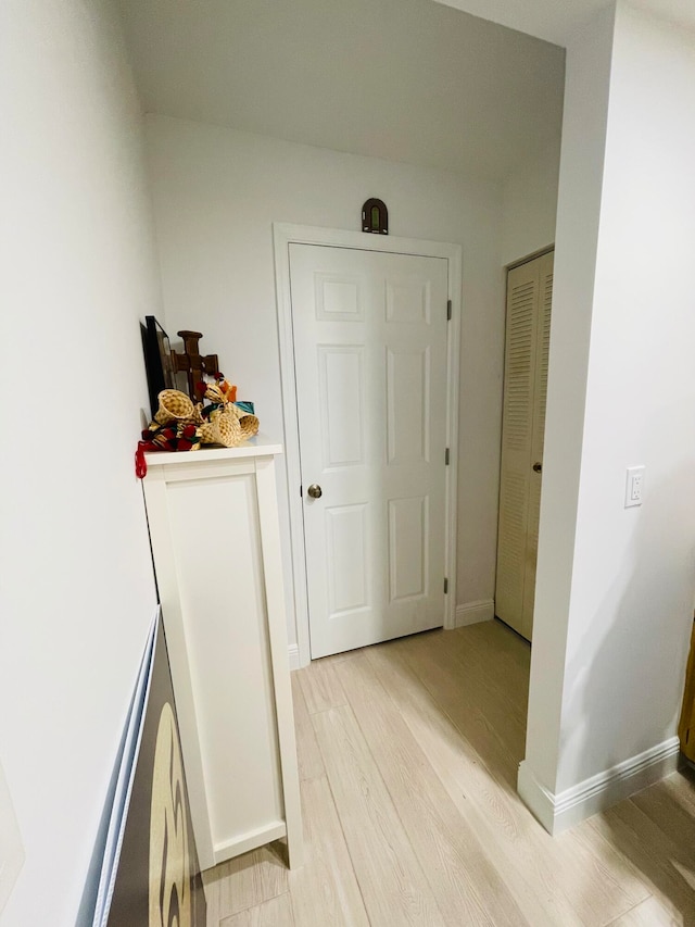 hall with light hardwood / wood-style floors