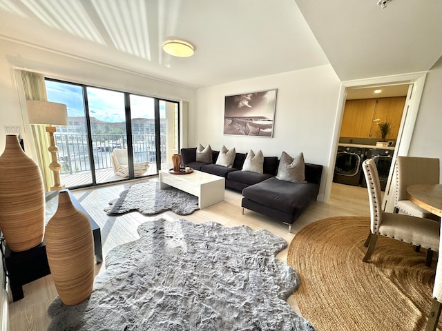 living room featuring light hardwood / wood-style flooring and washing machine and dryer