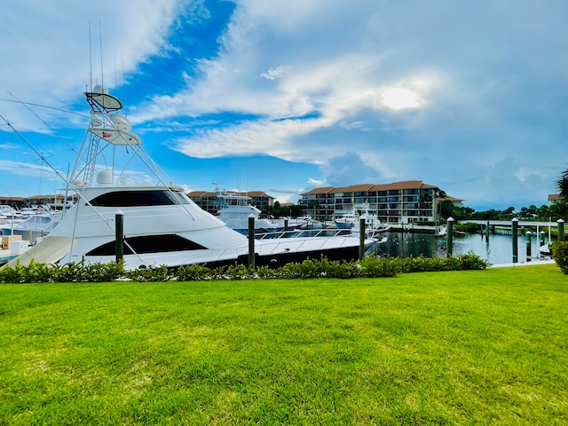 dock area featuring a lawn and a water view