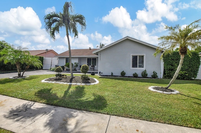 single story home featuring a front lawn and a garage