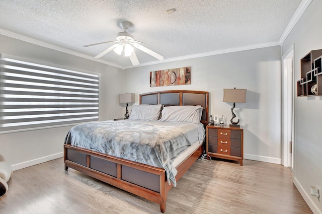 bedroom with ceiling fan, ornamental molding, a textured ceiling, and light hardwood / wood-style floors