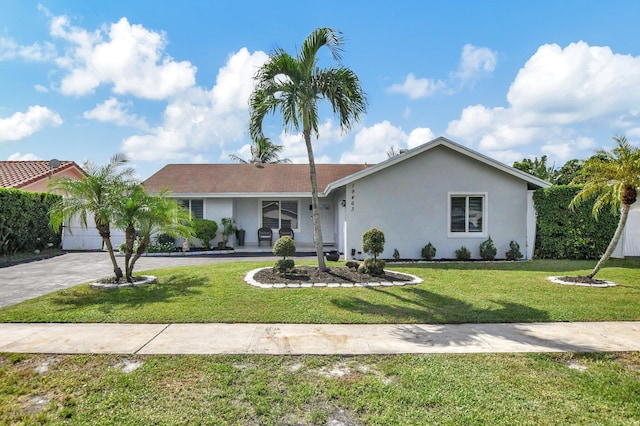 single story home with a garage and a front lawn