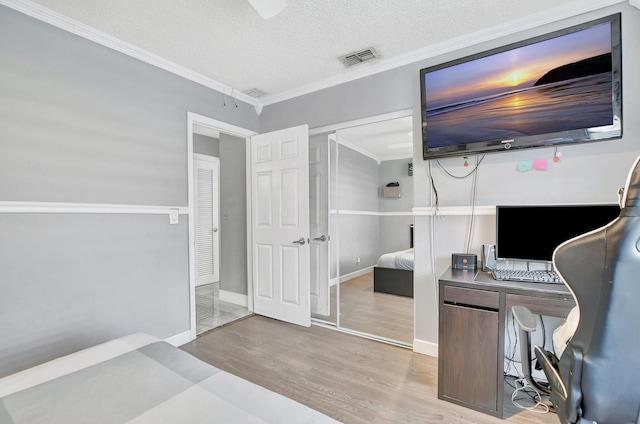 office area with ornamental molding, hardwood / wood-style floors, and a textured ceiling