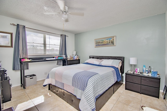 bedroom featuring ceiling fan, baseboards, a textured ceiling, and light tile patterned flooring