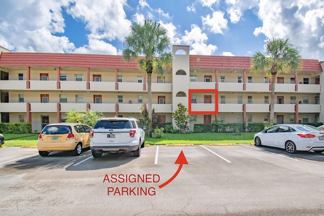 view of property featuring uncovered parking