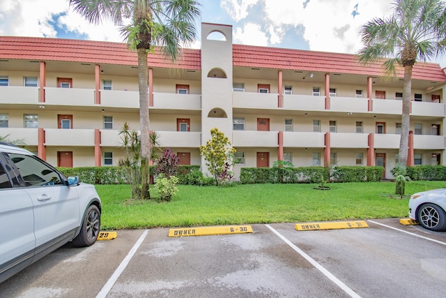 view of property featuring uncovered parking