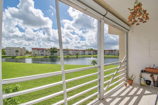 sunroom featuring a water view and plenty of natural light