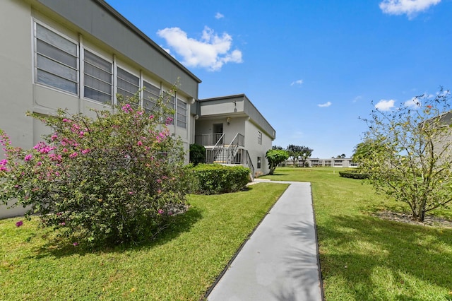 view of home's community with a lawn