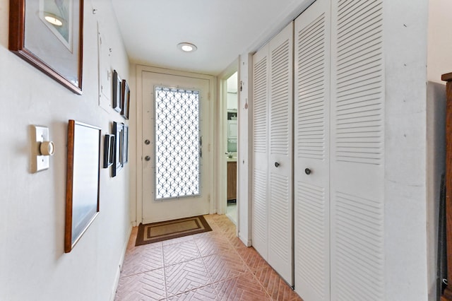 doorway to outside featuring light parquet floors