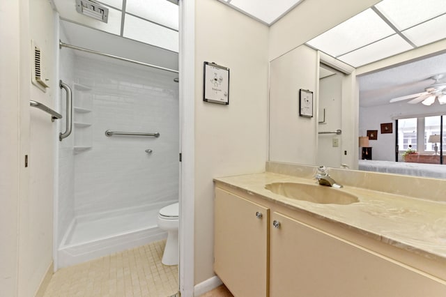 bathroom with tile patterned floors, toilet, a shower, ceiling fan, and vanity