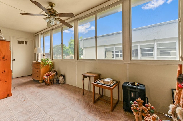 sunroom / solarium with ceiling fan and plenty of natural light