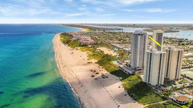 bird's eye view featuring a water view and a beach view