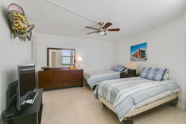 tiled bedroom featuring a textured ceiling and ceiling fan