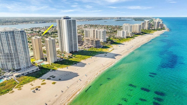 birds eye view of property featuring a water view and a view of the beach