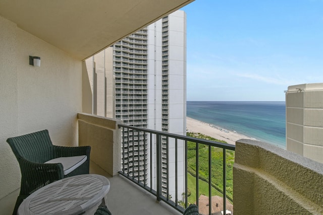 balcony with a water view and a beach view