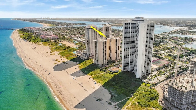 birds eye view of property with a water view and a beach view