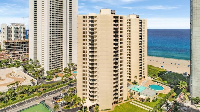 view of building exterior featuring a view of the beach and a water view