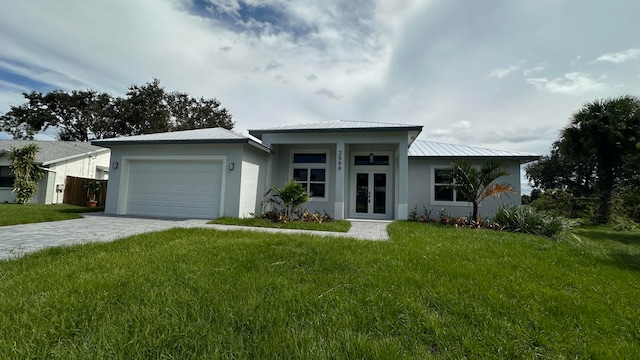 ranch-style home with a garage and a front lawn